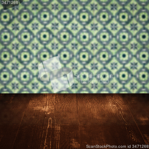 Image of Wood table top and blur vintage ceramic tile pattern wall