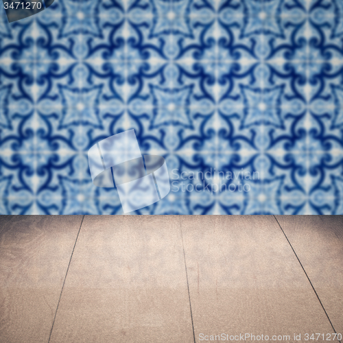 Image of Wood table top and blur vintage ceramic tile pattern wall