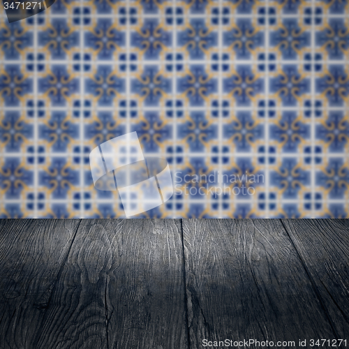 Image of Wood table top and blur vintage ceramic tile pattern wall