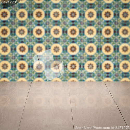 Image of Wood table top and blur vintage ceramic tile pattern wall