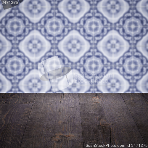 Image of Wood table top and blur vintage ceramic tile pattern wall