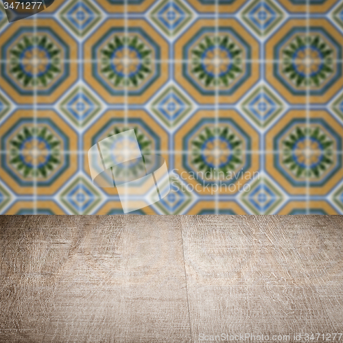 Image of Wood table top and blur vintage ceramic tile pattern wall