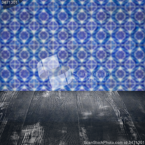 Image of Wood table top and blur vintage ceramic tile pattern wall
