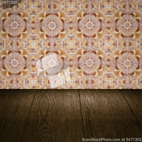 Image of Wood table top and blur vintage ceramic tile pattern wall