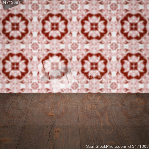 Image of Wood table top and blur vintage ceramic tile pattern wall