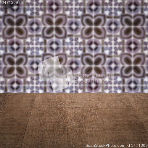 Image of Wood table top and blur vintage ceramic tile pattern wall