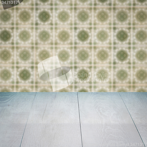 Image of Wood table top and blur vintage ceramic tile pattern wall