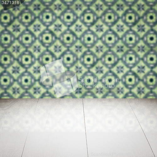 Image of Wood table top and blur vintage ceramic tile pattern wall
