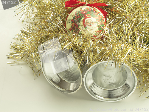 Image of silver bells with a santa bauble and tinsel