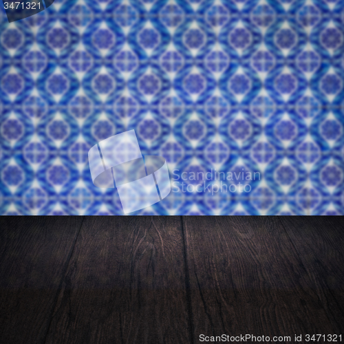 Image of Wood table top and blur vintage ceramic tile pattern wall
