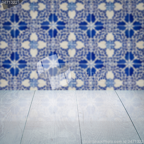 Image of Wood table top and blur vintage ceramic tile pattern wall
