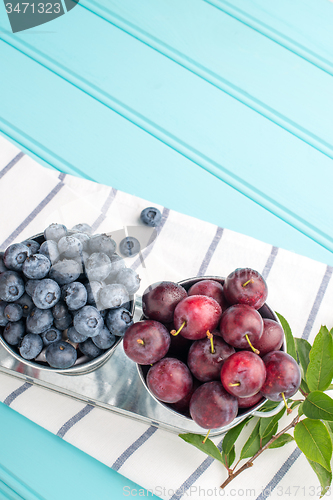 Image of Plums and blueberries in small metal bucket