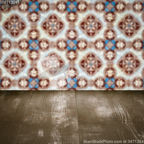 Image of Wood table top and blur vintage ceramic tile pattern wall
