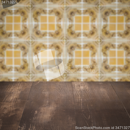 Image of Wood table top and blur vintage ceramic tile pattern wall