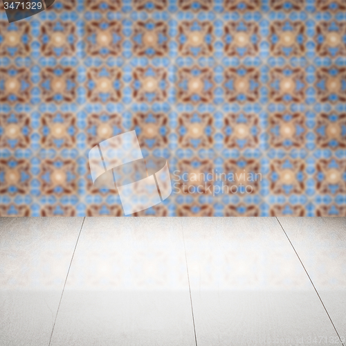 Image of Wood table top and blur vintage ceramic tile pattern wall