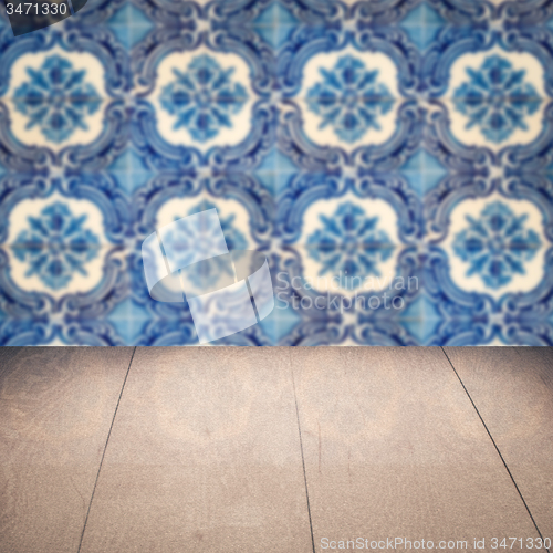 Image of Wood table top and blur vintage ceramic tile pattern wall