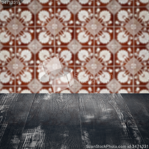 Image of Wood table top and blur vintage ceramic tile pattern wall