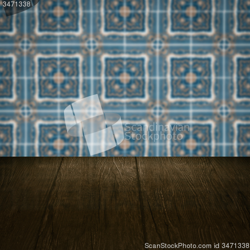 Image of Wood table top and blur vintage ceramic tile pattern wall