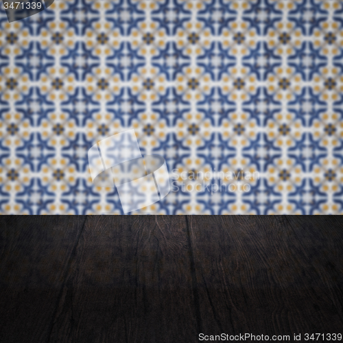 Image of Wood table top and blur vintage ceramic tile pattern wall
