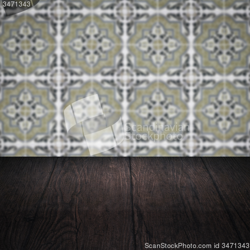 Image of Wood table top and blur vintage ceramic tile pattern wall