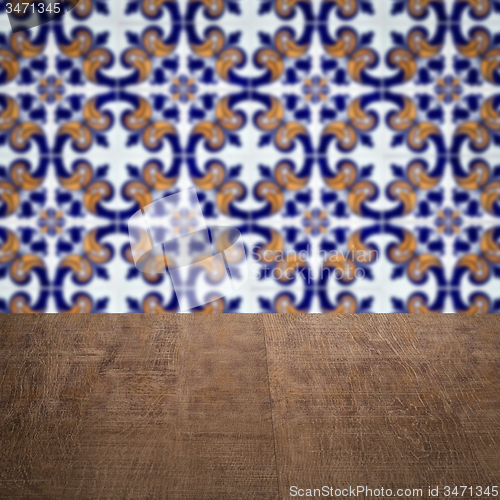 Image of Wood table top and blur vintage ceramic tile pattern wall