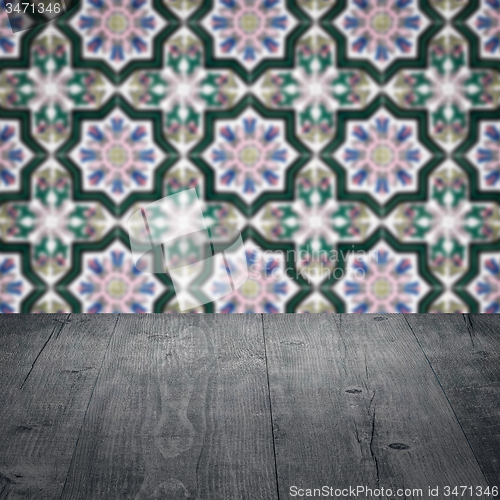 Image of Wood table top and blur vintage ceramic tile pattern wall