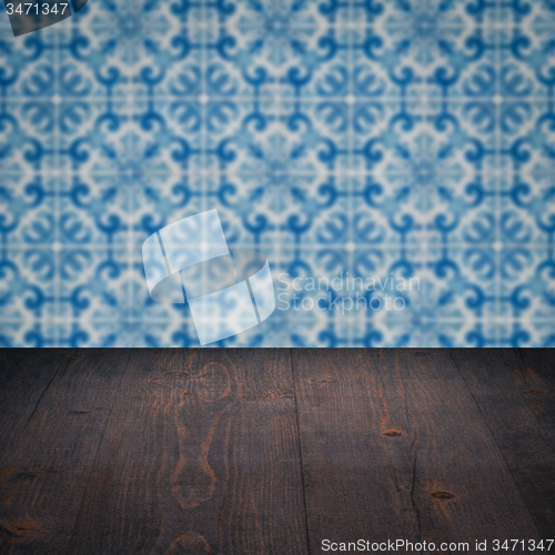 Image of Wood table top and blur vintage ceramic tile pattern wall