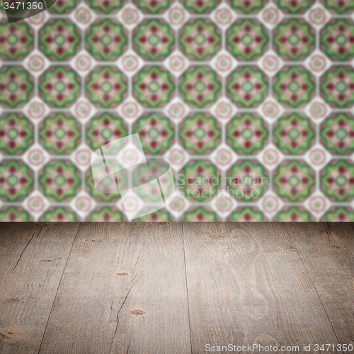 Image of Wood table top and blur vintage ceramic tile pattern wall