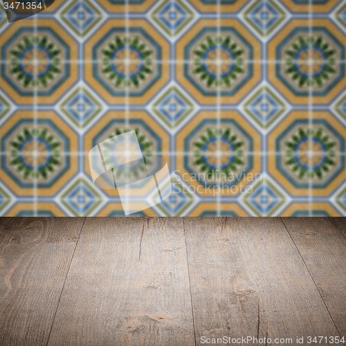 Image of Wood table top and blur vintage ceramic tile pattern wall