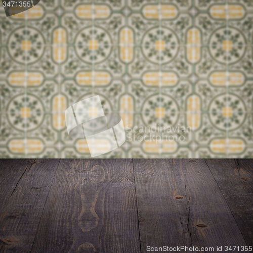 Image of Wood table top and blur vintage ceramic tile pattern wall