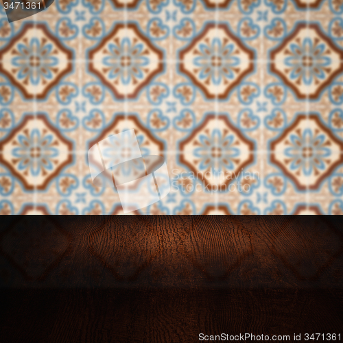 Image of Wood table top and blur vintage ceramic tile pattern wall