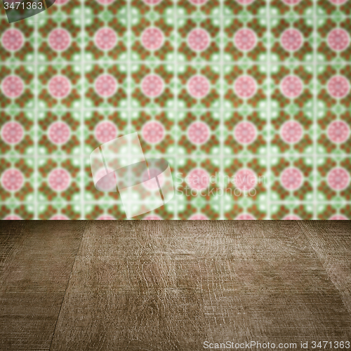 Image of Wood table top and blur vintage ceramic tile pattern wall