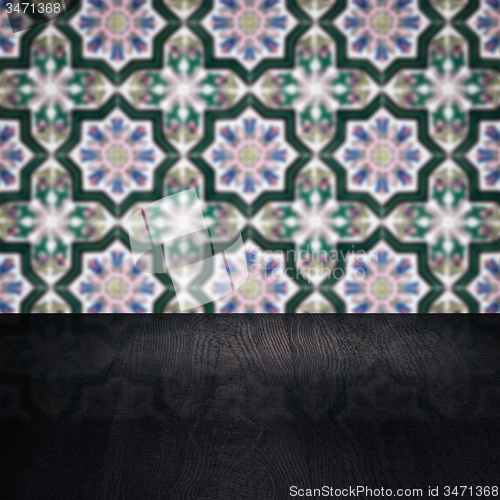 Image of Wood table top and blur vintage ceramic tile pattern wall