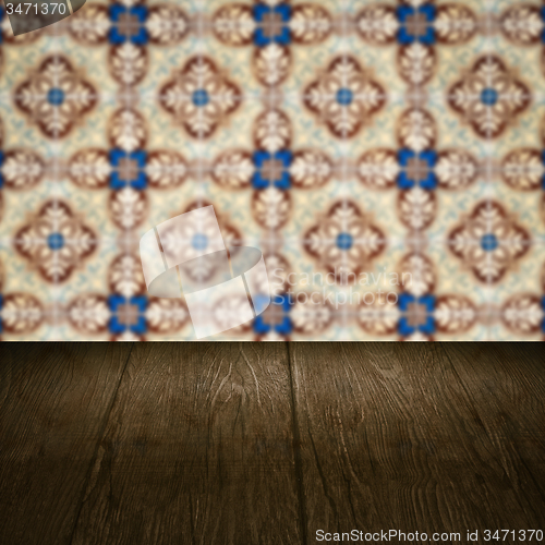Image of Wood table top and blur vintage ceramic tile pattern wall