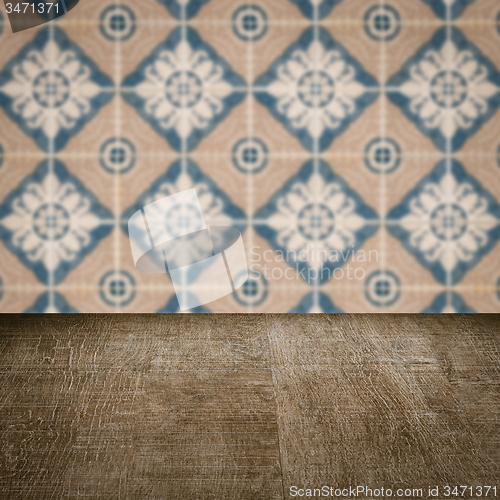 Image of Wood table top and blur vintage ceramic tile pattern wall