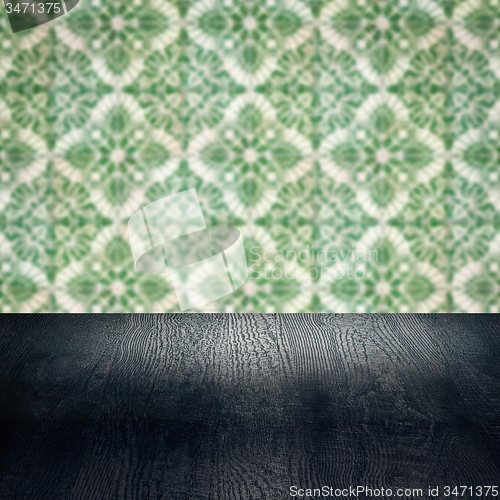Image of Wood table top and blur vintage ceramic tile pattern wall