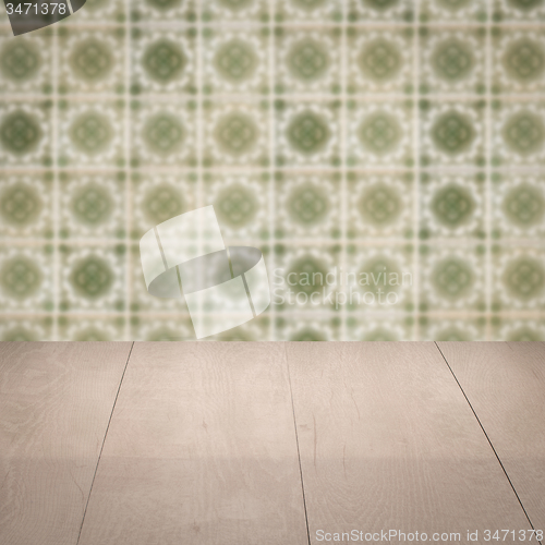 Image of Wood table top and blur vintage ceramic tile pattern wall