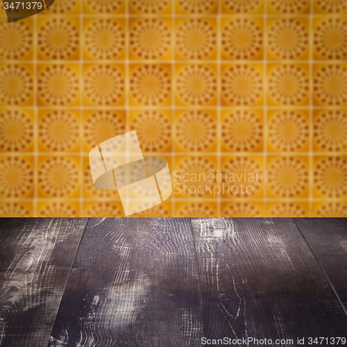 Image of Wood table top and blur vintage ceramic tile pattern wall