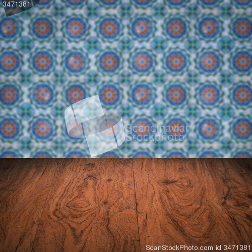 Image of Wood table top and blur vintage ceramic tile pattern wall