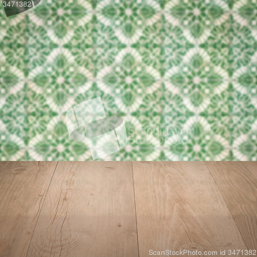 Image of Wood table top and blur vintage ceramic tile pattern wall