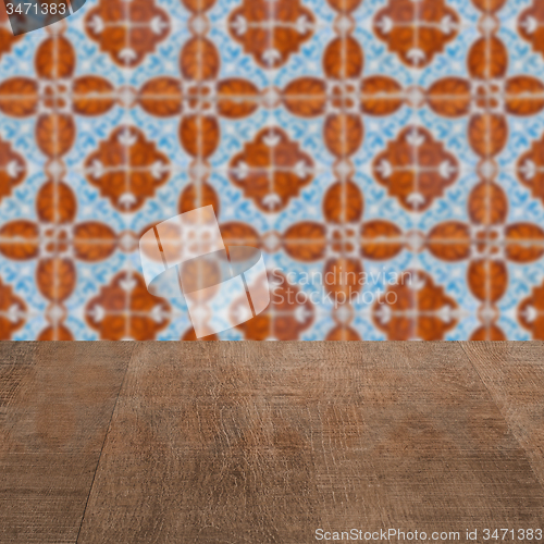 Image of Wood table top and blur vintage ceramic tile pattern wall