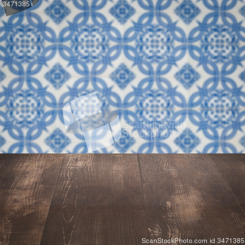 Image of Wood table top and blur vintage ceramic tile pattern wall