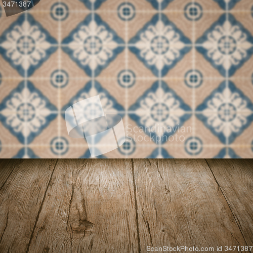 Image of Wood table top and blur vintage ceramic tile pattern wall
