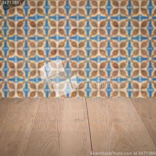 Image of Wood table top and blur vintage ceramic tile pattern wall