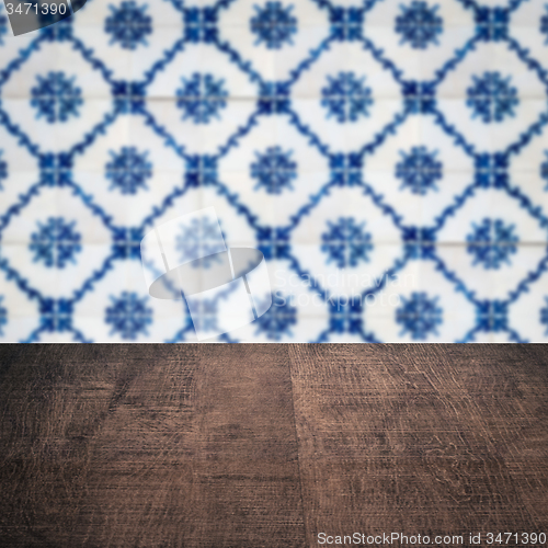 Image of Wood table top and blur vintage ceramic tile pattern wall