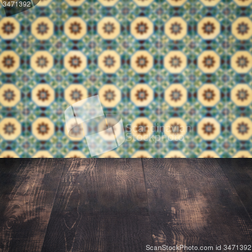 Image of Wood table top and blur vintage ceramic tile pattern wall