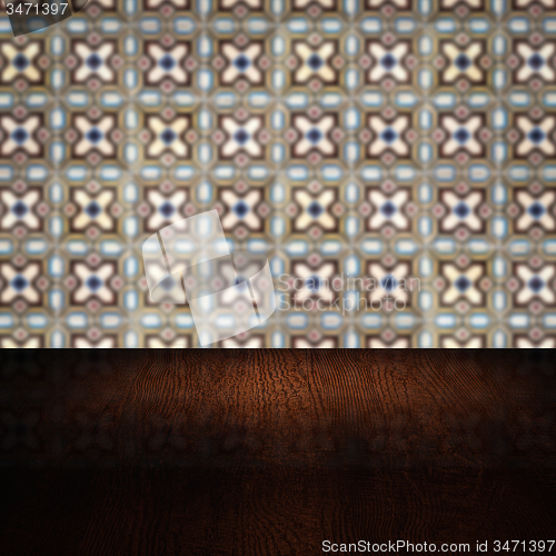 Image of Wood table top and blur vintage ceramic tile pattern wall