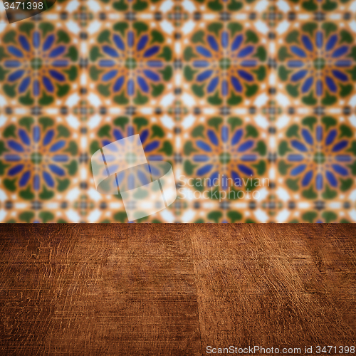 Image of Wood table top and blur vintage ceramic tile pattern wall