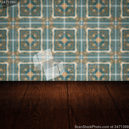 Image of Wood table top and blur vintage ceramic tile pattern wall