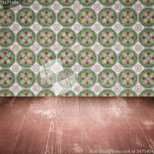 Image of Wood table top and blur vintage ceramic tile pattern wall